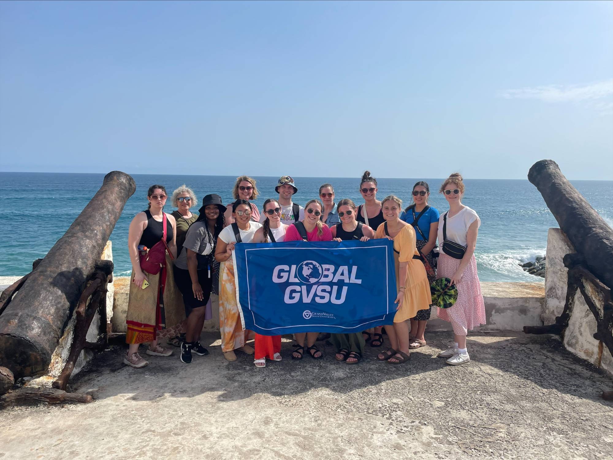 Ghana group near cannons with gvsu global banner